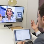 Businessman on video conference with her colleague in office job