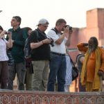 “Tourist taking photographs in India”